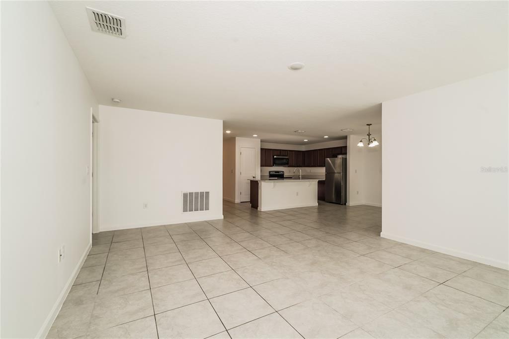 1473 Lucerne Loop Road Northeast Winter Haven, FL 33881 - Photo 5 of 25 a view of kitchen with refrigerator and white stove top oven