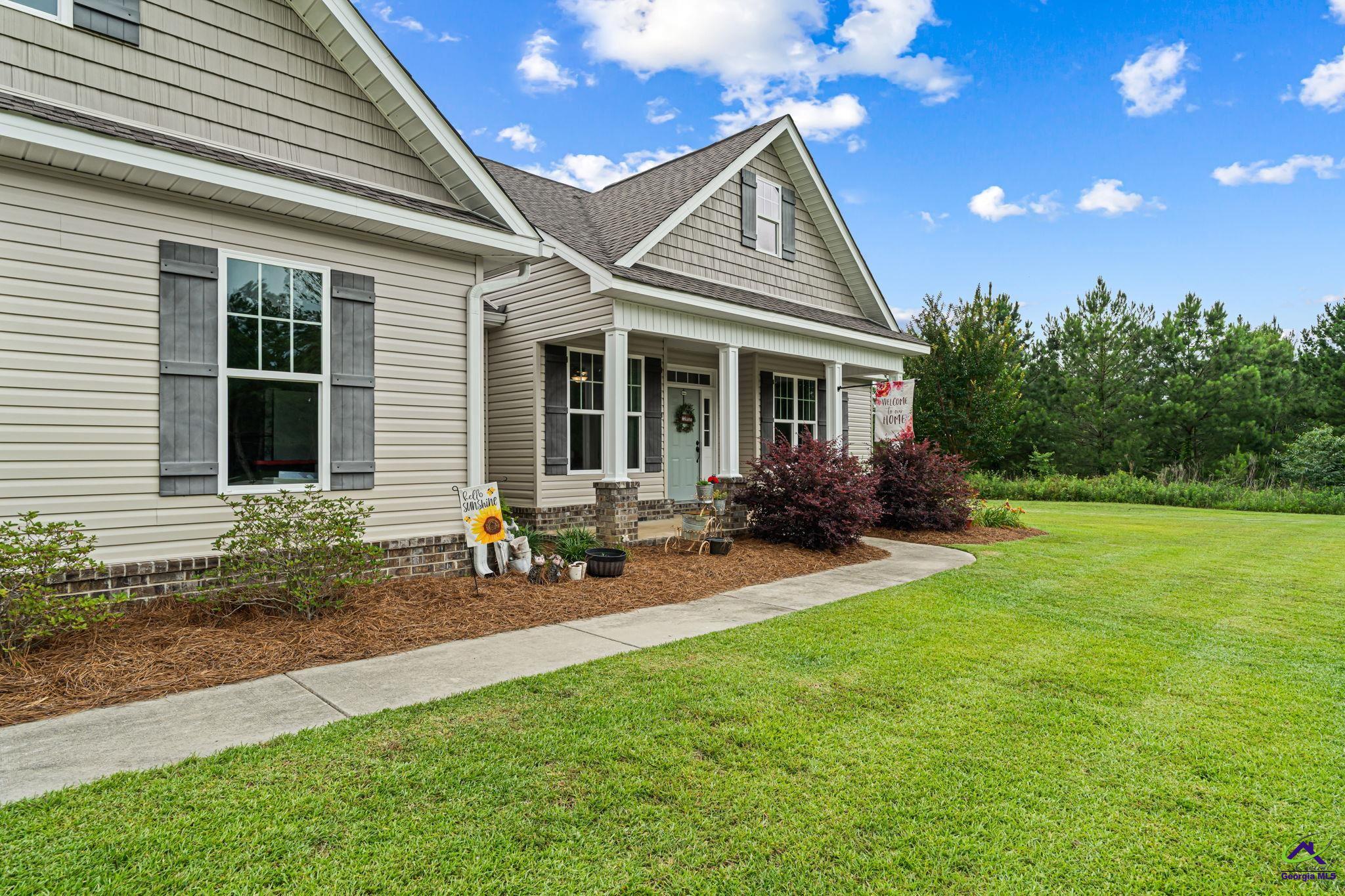 180 Woodland Trail Road Cochran, GA 31014 - Photo 2 of 25 a view of a house with backyard sitting area and garden