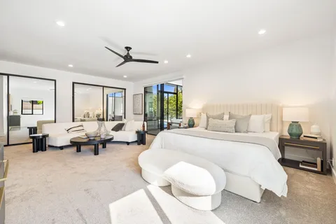 a bedroom with a bed and a chandelier