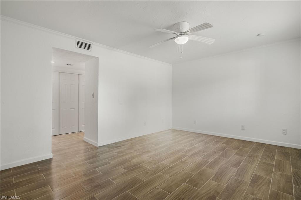 16540 Partridge Club Road, Unit 103 Fort Myers, FL 33908 - Photo 14 of 36 wooden floor in an empty room