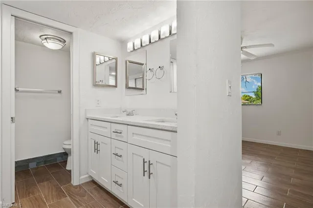 a spacious bathroom with a double vanity sink and a mirror