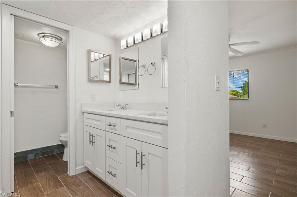 16540 Partridge Club Road, Unit 103 Fort Myers, FL 33908 - Photo 17 of 36 a spacious bathroom with a double vanity sink and a mirror