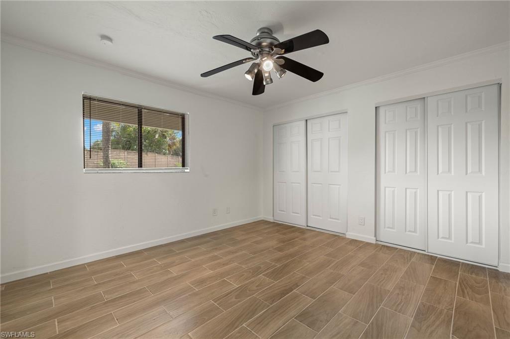 16540 Partridge Club Road, Unit 103 Fort Myers, FL 33908 - Photo 21 of 36 a view of empty room with wooden floor and fan