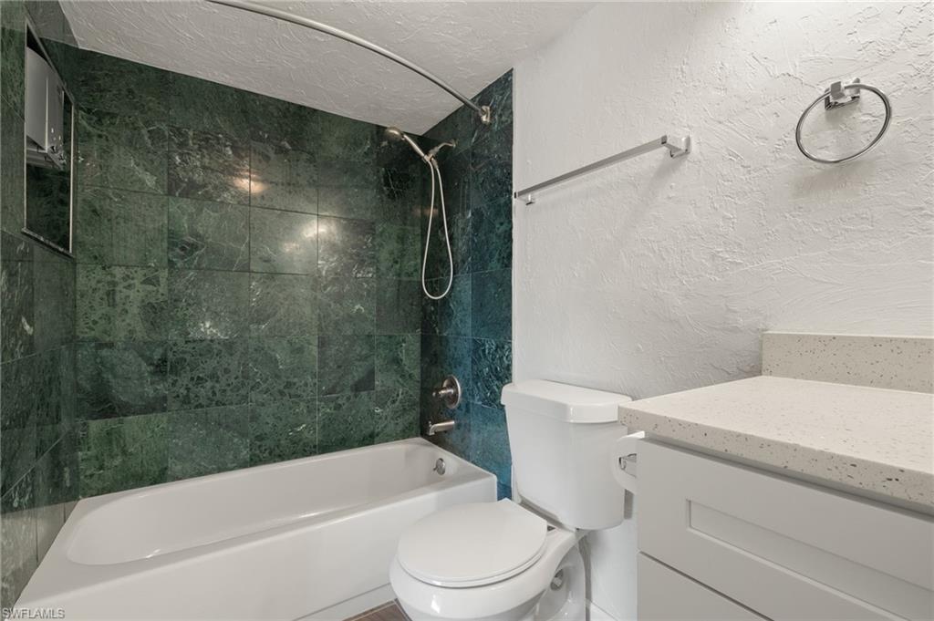 16540 Partridge Club Road, Unit 103 Fort Myers, FL 33908 - Photo 24 of 36 a bathroom with a toilet and a shower