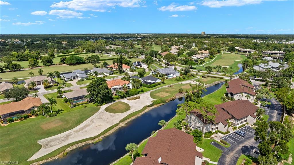 16540 Partridge Club Road, Unit 103 Fort Myers, FL 33908 - Photo 28 of 36 an aerial view of residential houses with outdoor space and ocean view
