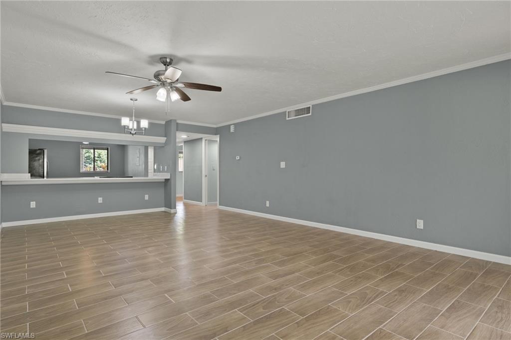 16540 Partridge Club Road, Unit 103 Fort Myers, FL 33908 - Photo 5 of 36 a view of a livingroom with a ceiling fan window and wooden floor