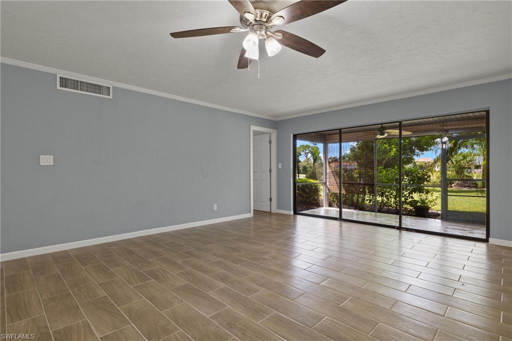 16540 Partridge Club Road, Unit 103 Fort Myers, FL 33908 - Photo 6 of 36 a view of an empty room with wooden floor and a window