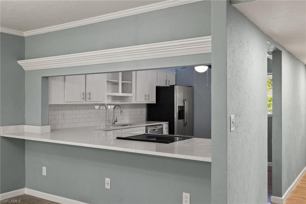 16540 Partridge Club Road, Unit 103 Fort Myers, FL 33908 - Photo 9 of 36 a kitchen with a refrigerator and a sink