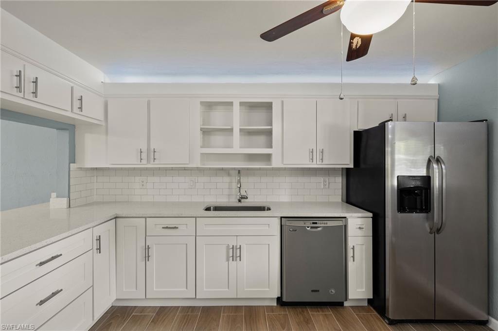 16540 Partridge Club Road, Unit 103 Fort Myers, FL 33908 - Photo 10 of 36 a kitchen with a sink dishwasher a refrigerator and cabinets
