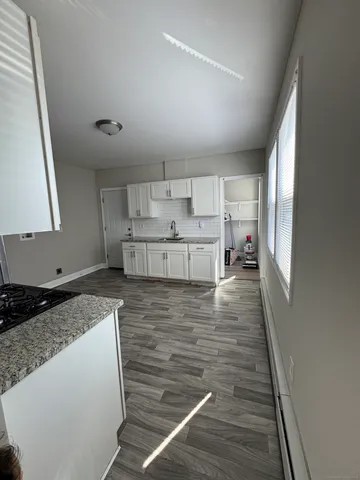a kitchen with a stove and white cabinets
