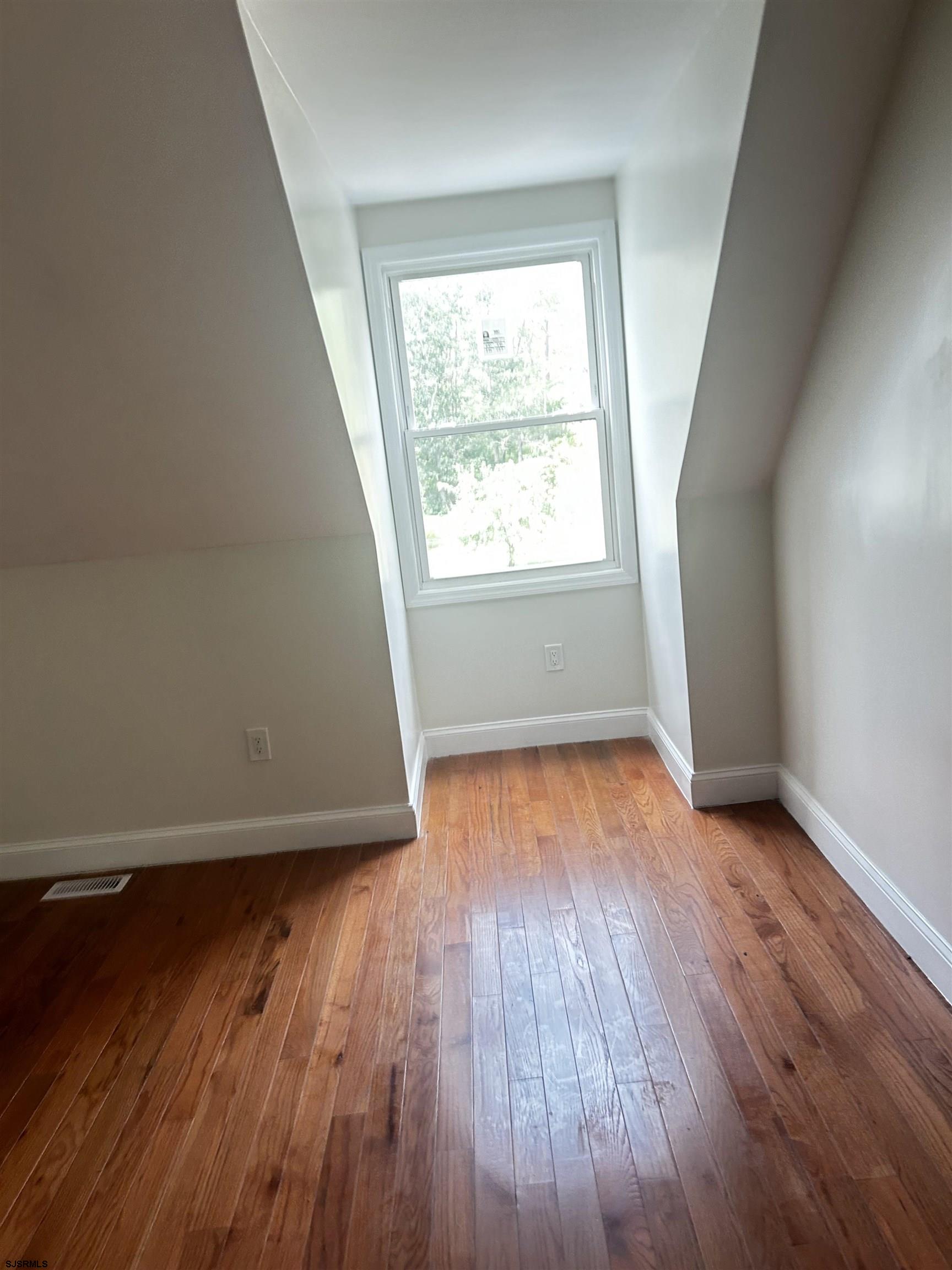 715 Ramah Road Millville, NJ 08332 - Photo 17 of 42 an empty room with wooden floor and windows