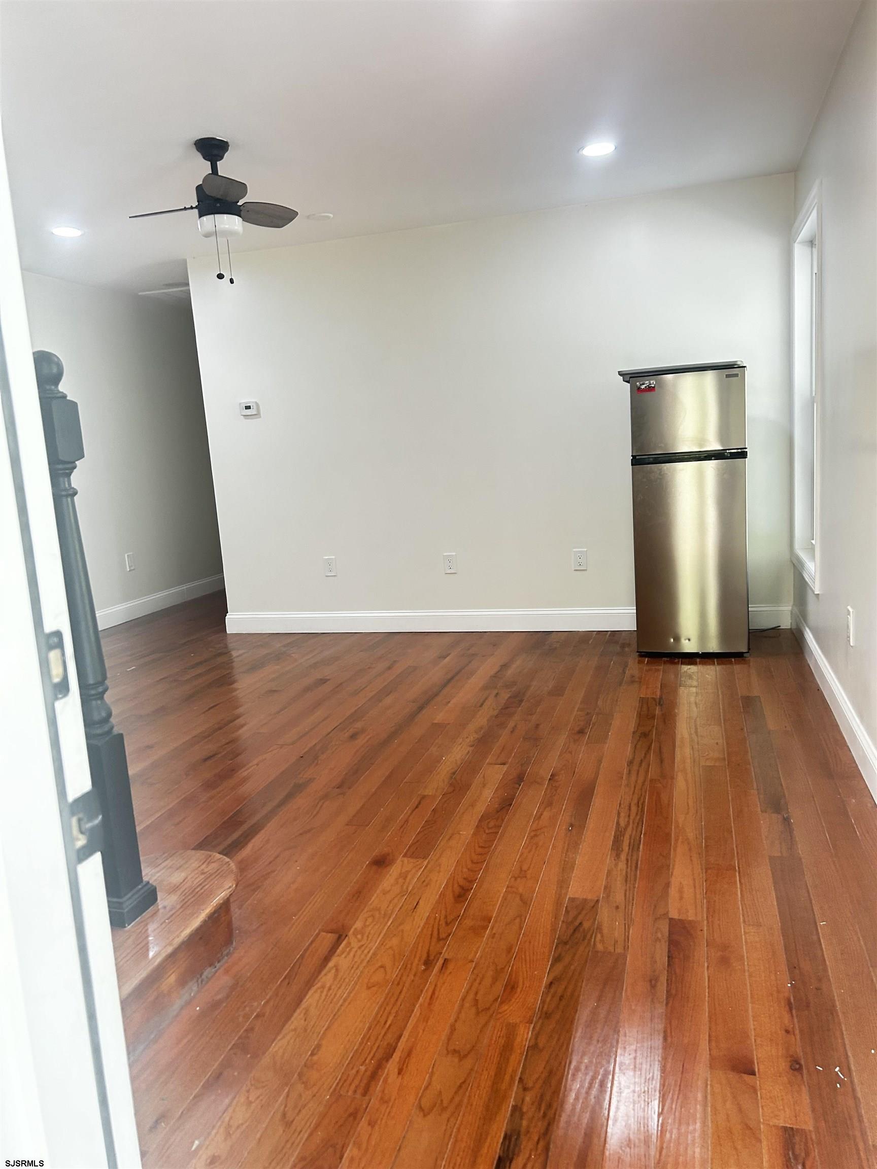 715 Ramah Road Millville, NJ 08332 - Photo 18 of 42 a view of empty room with wooden floor and kitchen