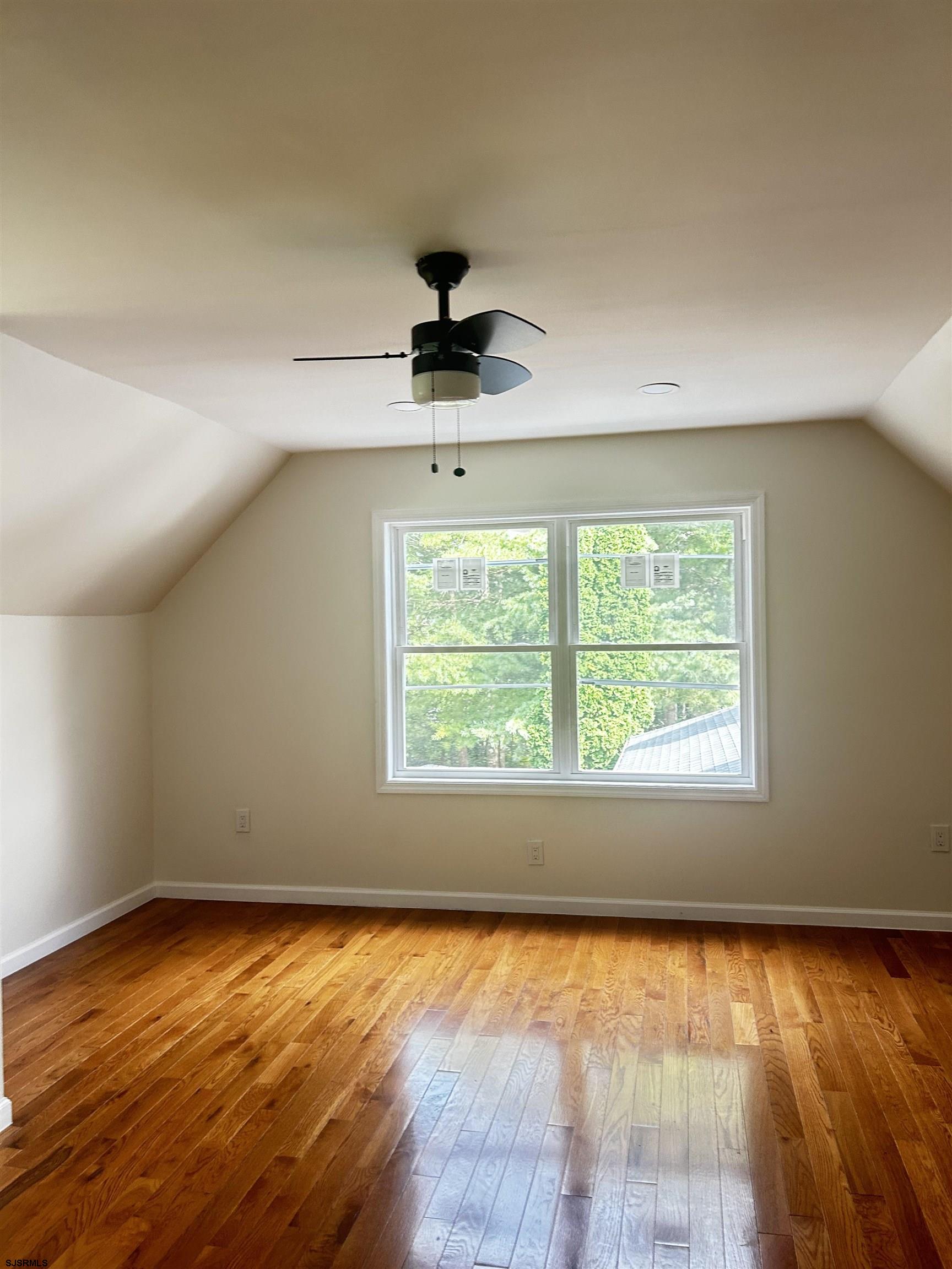 715 Ramah Road Millville, NJ 08332 - Photo 33 of 42 an empty room with wooden floor and windows
