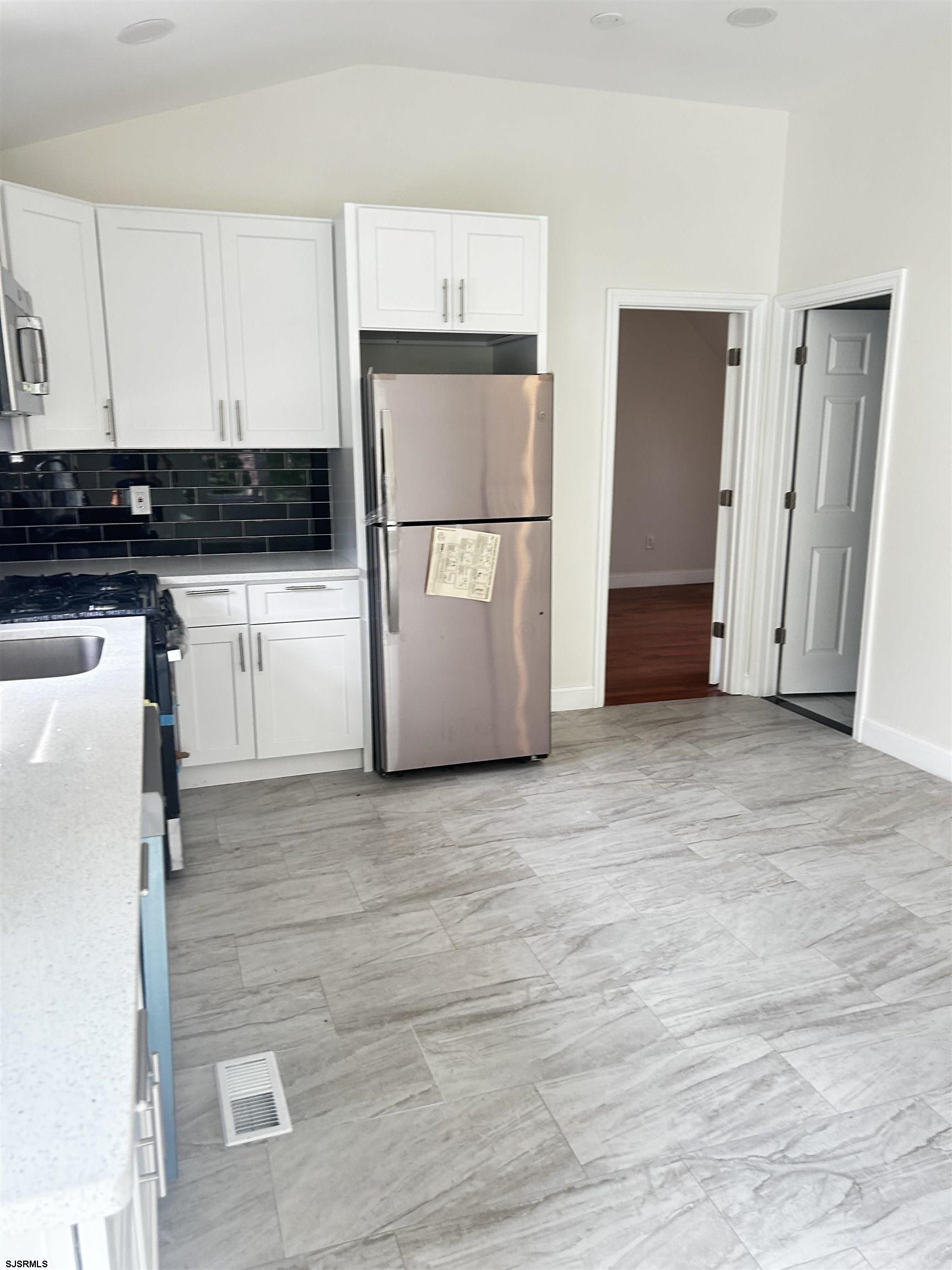 715 Ramah Road Millville, NJ 08332 - Photo 4 of 42 a view of kitchen with refrigerator cabinets and wooden floor