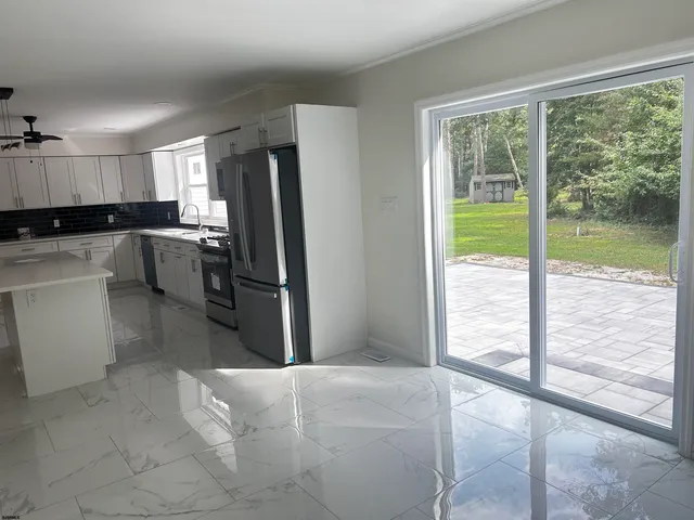 a kitchen with a sink stove and microwave