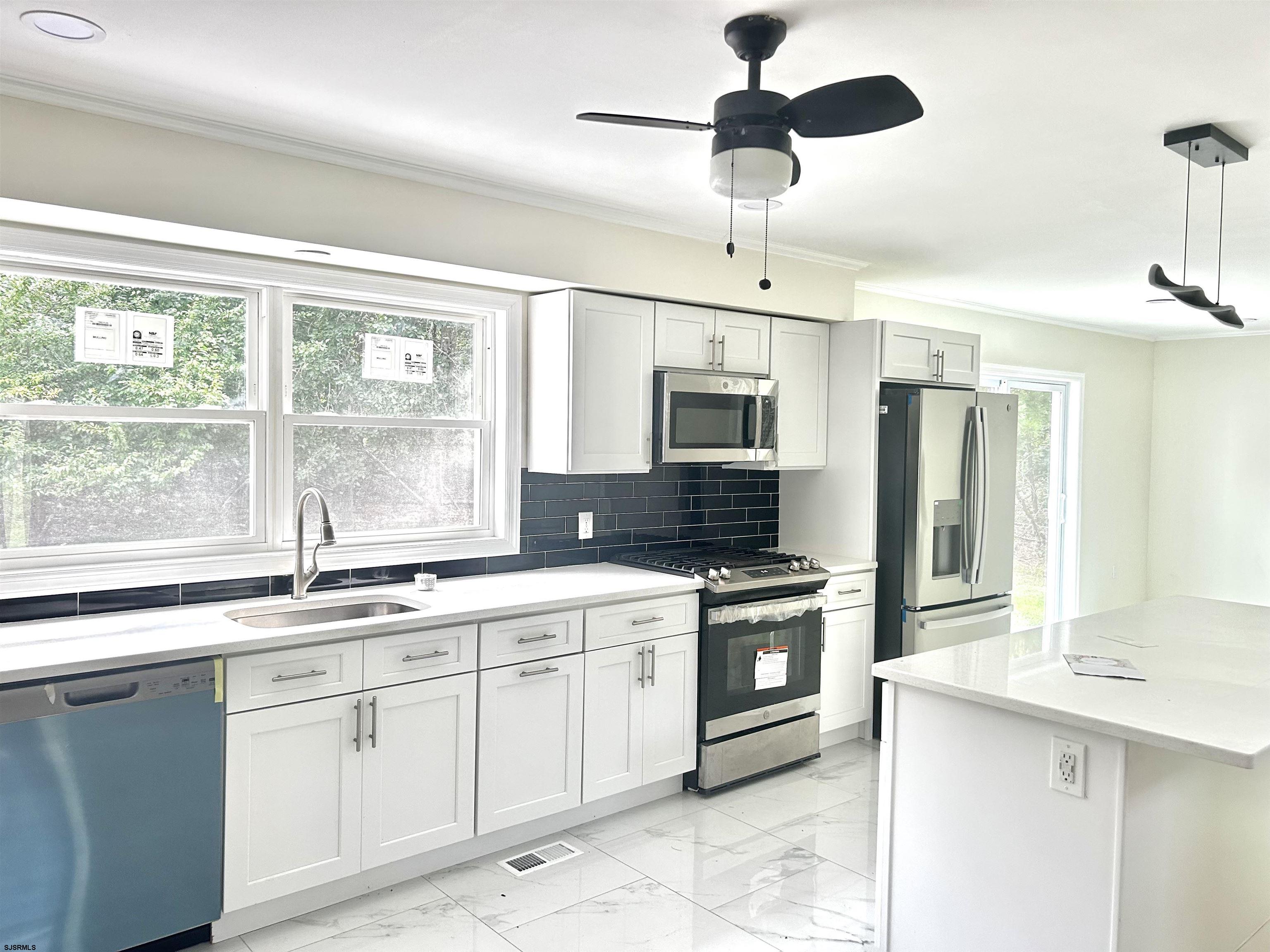 715 Ramah Road Millville, NJ 08332 - Photo 8 of 42 a kitchen with a sink stove and microwave
