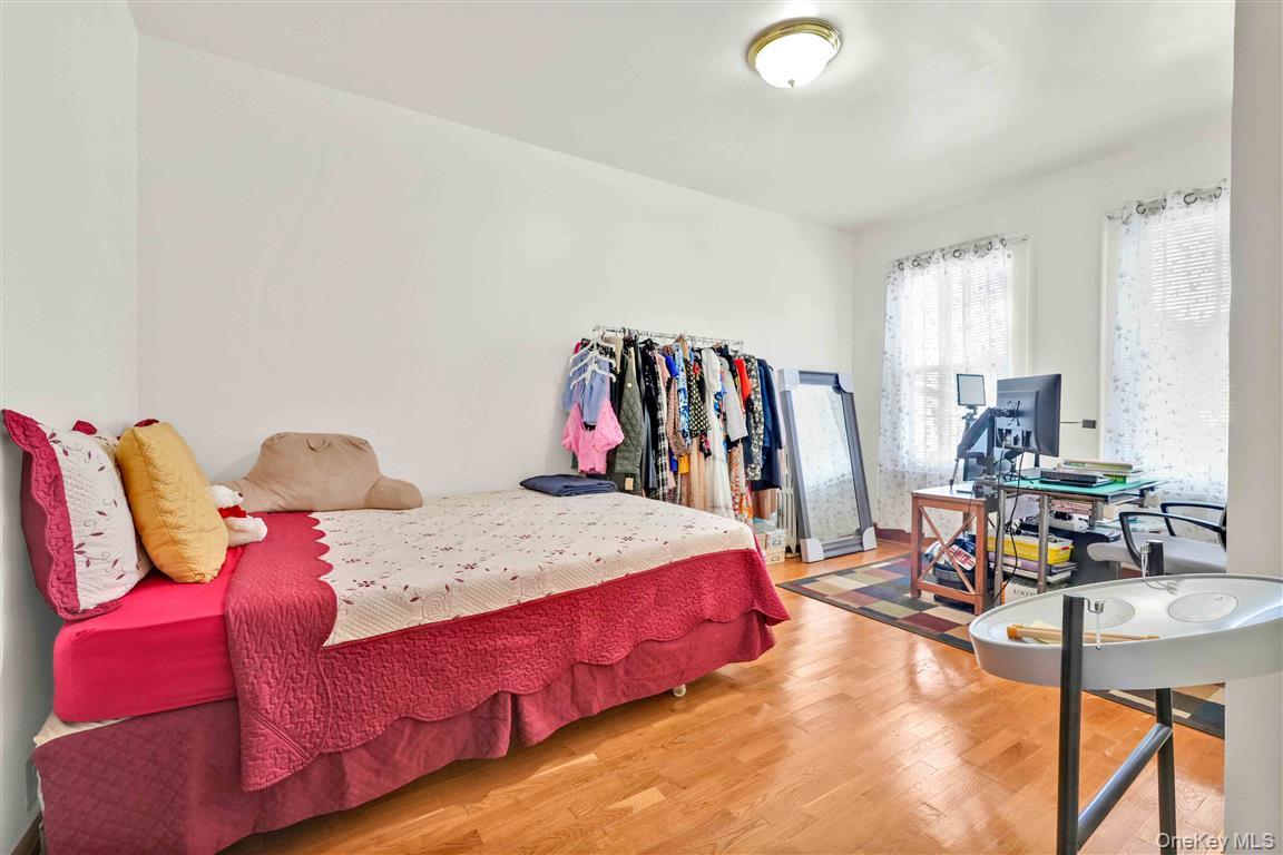 104-21 92nd Avenue Queens, NY 11418 - Photo 17 of 48 a bed room with a bed and a chair