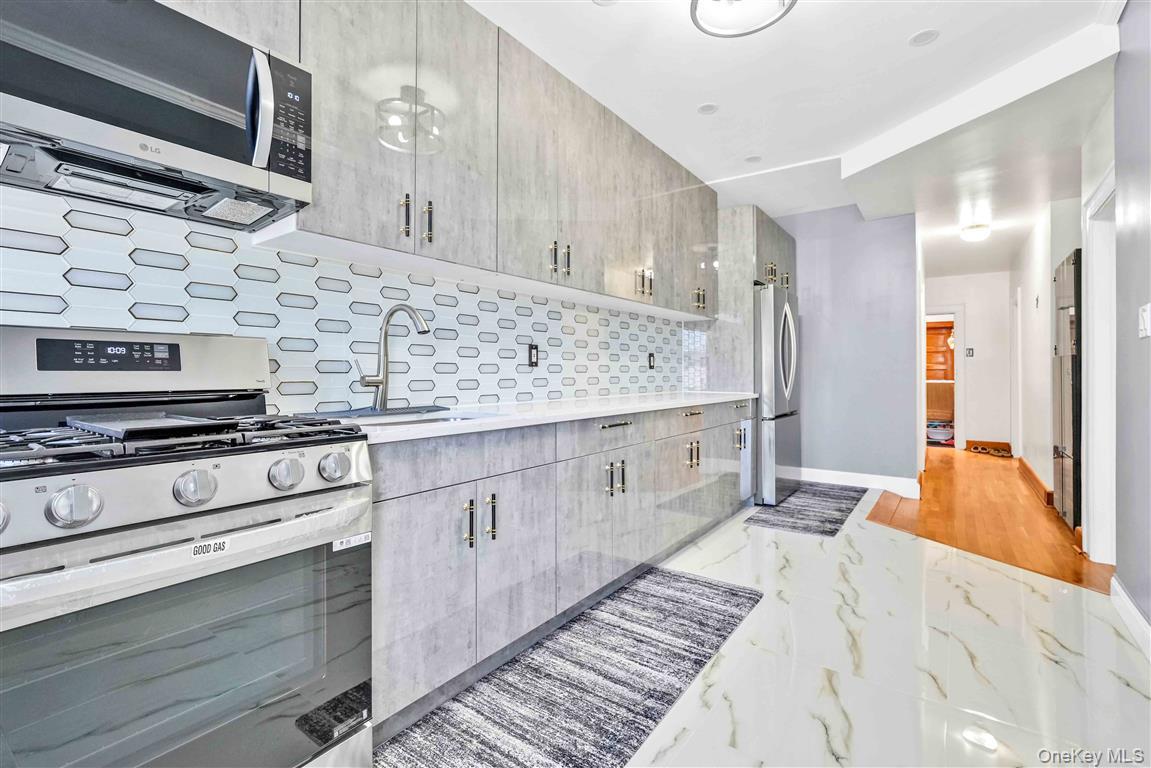 104-21 92nd Avenue Queens, NY 11418 - Photo 23 of 48 a kitchen with stainless steel appliances granite countertop a stove and a sink