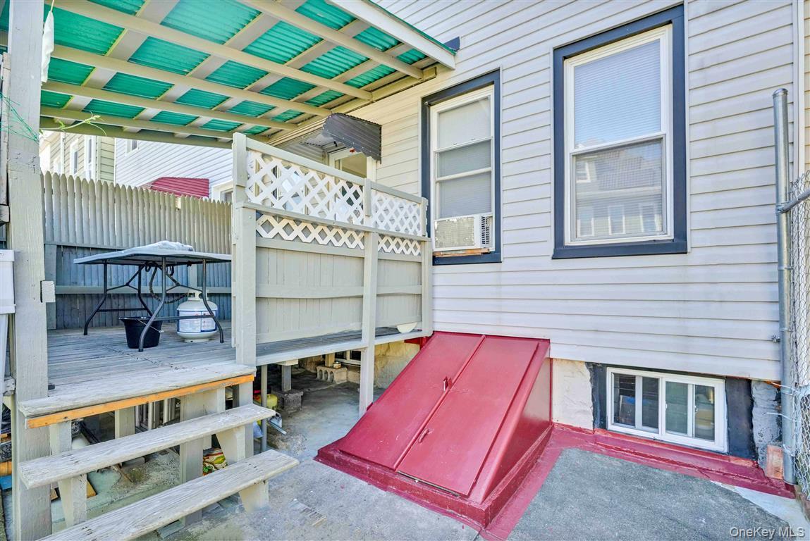 104-21 92nd Avenue Queens, NY 11418 - Photo 37 of 48 a view of backyard with a deck and a wooden bench