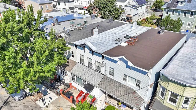 an aerial view of multiple houses with yard