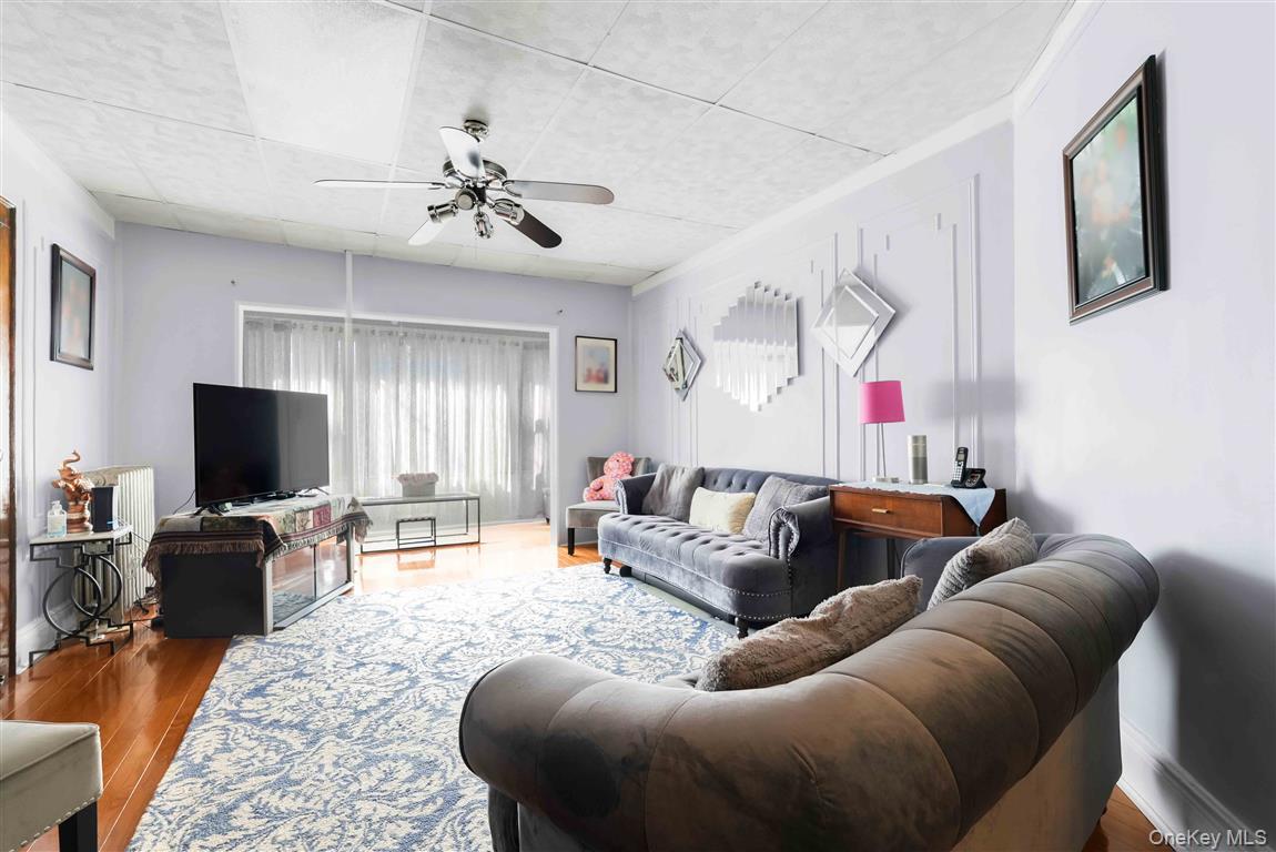 104-21 92nd Avenue Queens, NY 11418 - Photo 4 of 48 a living room with furniture and a flat screen tv