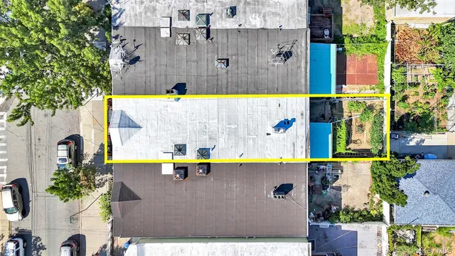 an aerial view of a residential apartment building with a yard and a lot of stuff