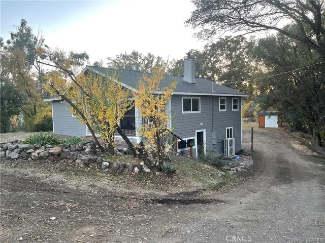 a view of a house with a yard and wooden fence