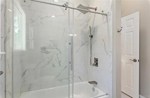 a bathroom with a shower and a glass door