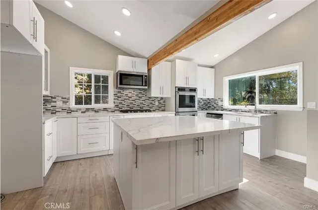a kitchen with counter top space cabinets and appliances