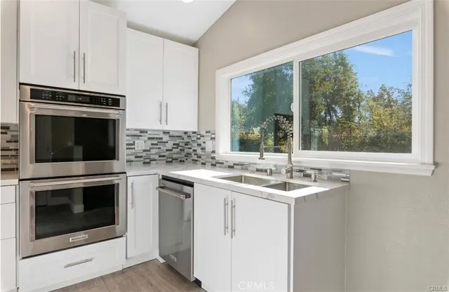 a kitchen with a stove oven and a sink