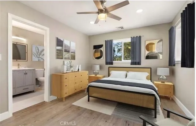 a bedroom with a large bed and windows