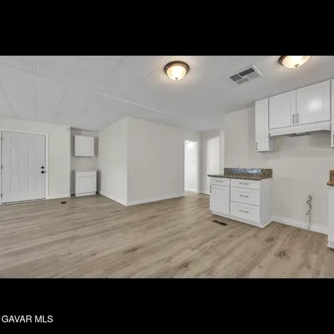 a view of kitchen with wooden floor