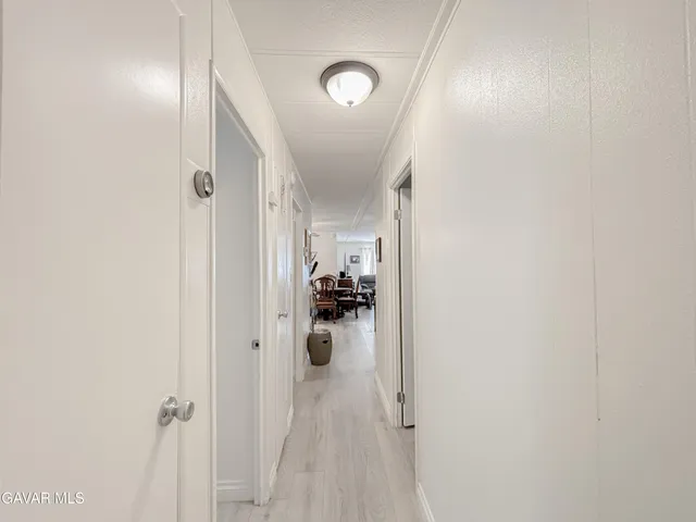 a view of a hallway with a livingroom and a hallway