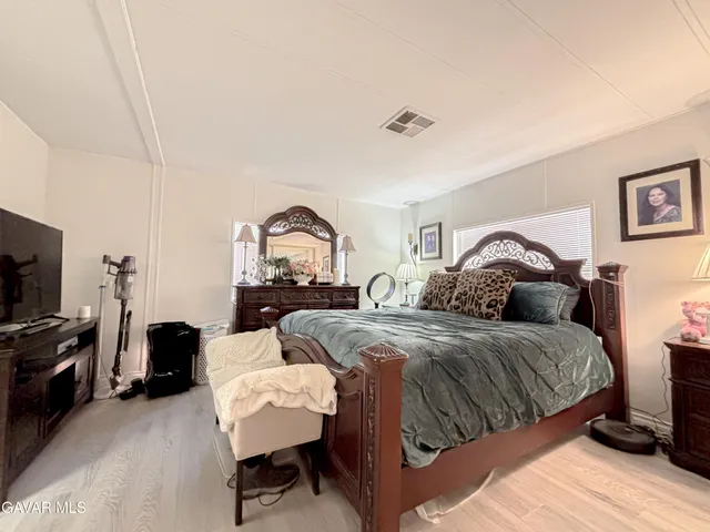 a bedroom with two beds and a television