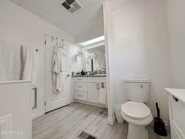 a bathroom with a toilet sink and a mirror