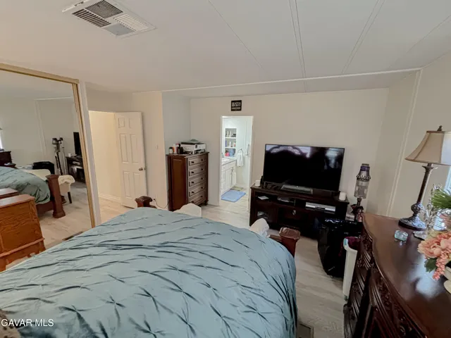 a bedroom with a bed and a television