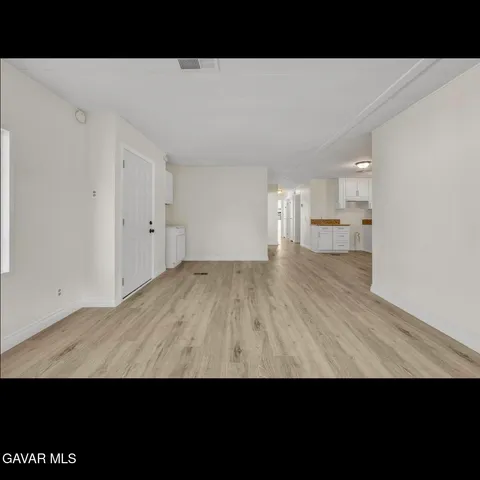 a view of a patio with table and chairs potted plants with wooden floor and fence