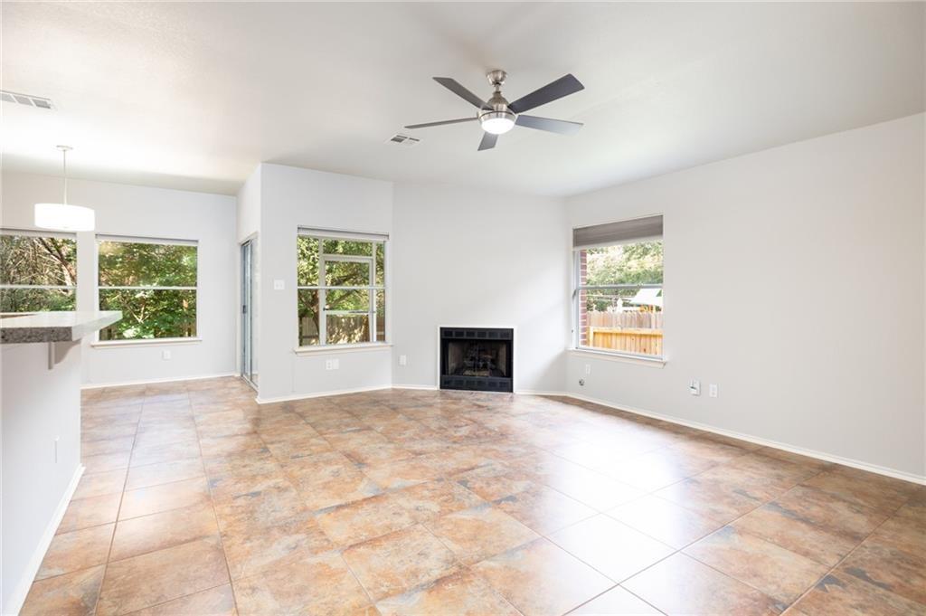 4526 Corran Ferry Loop Austin, TX 78749 - Photo 10 of 25 An open living space features durable tile flooring and a corner fireplace.