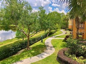5447 Vineland Road, Unit 1303 Orlando, FL 32811 - Photo 18 of 18 a view of a yard with plants and large trees