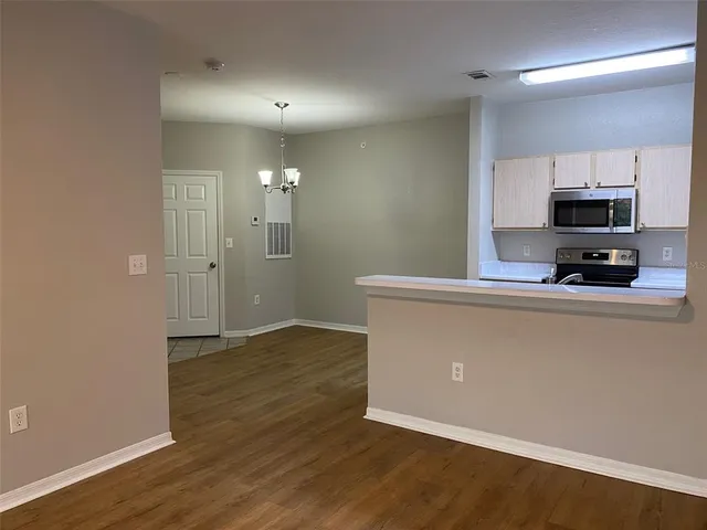 a view of kitchen with wooden floor