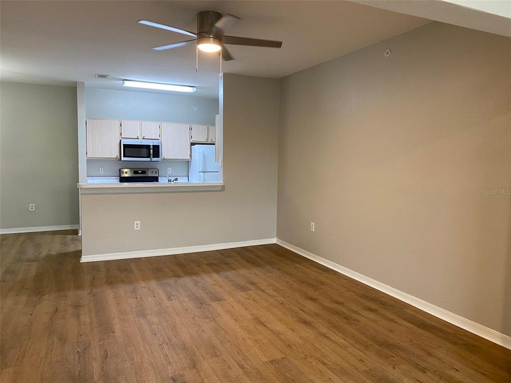 5447 Vineland Road, Unit 1303 Orlando, FL 32811 - Photo 8 of 18 a view of a kitchen with a sink and a microwave