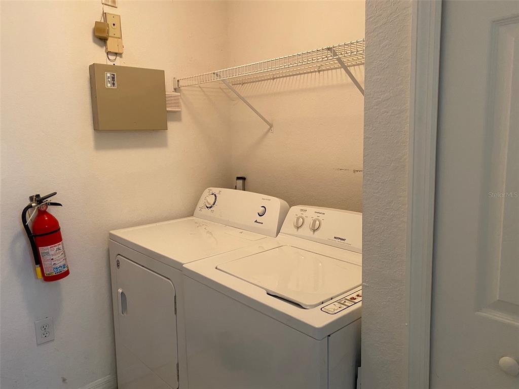 5447 Vineland Road, Unit 1303 Orlando, FL 32811 - Photo 9 of 18 a utility room with dryer and washer