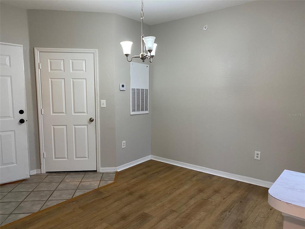5447 Vineland Road, Unit 1303 Orlando, FL 32811 - Photo 10 of 18 wooden floor in an empty room with a window