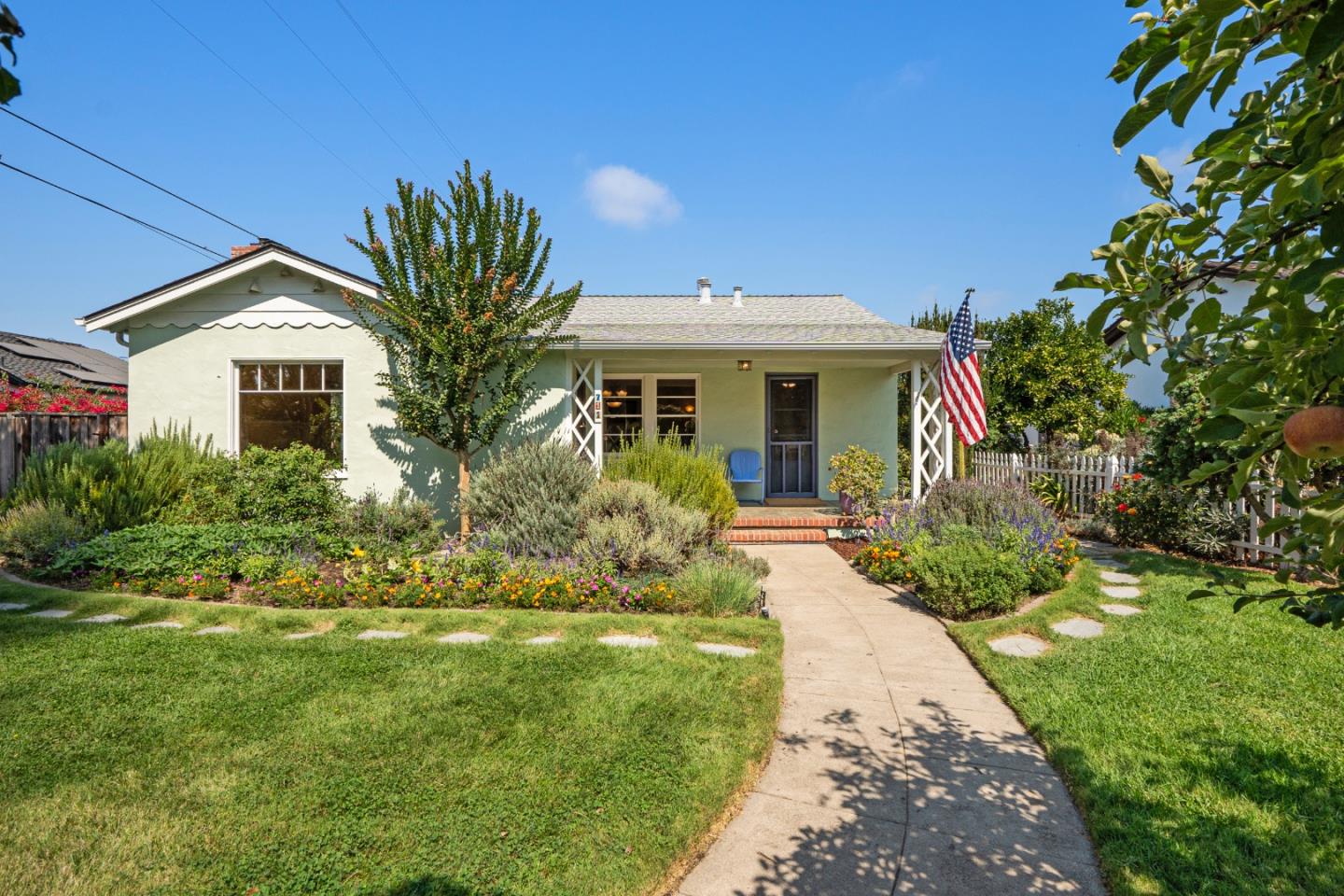 a front view of a house with a garden
