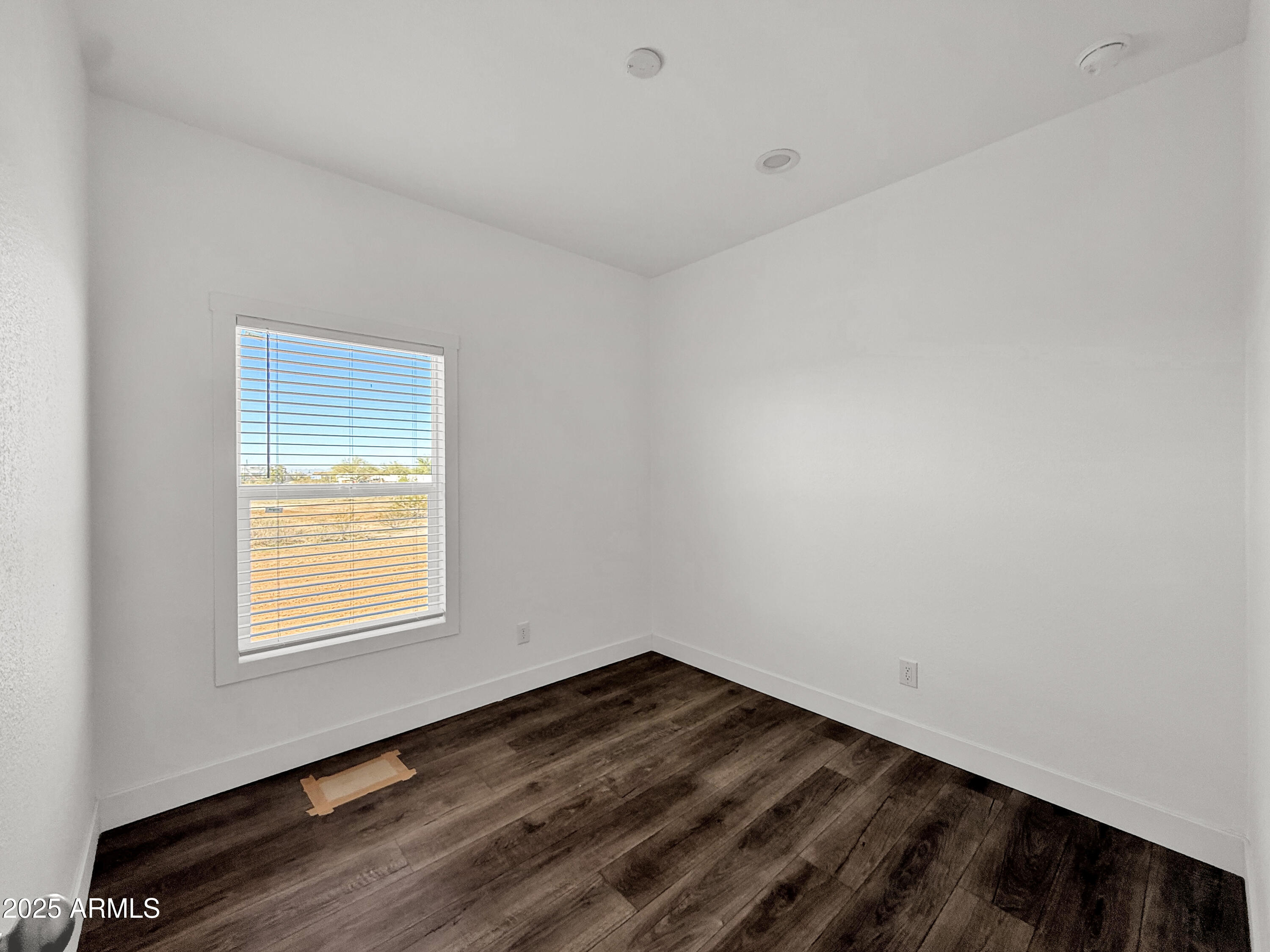 8548 North Page Road Florence, AZ 85132 - Photo 12 of 23 a view of a room that has wooden floor and windows in it