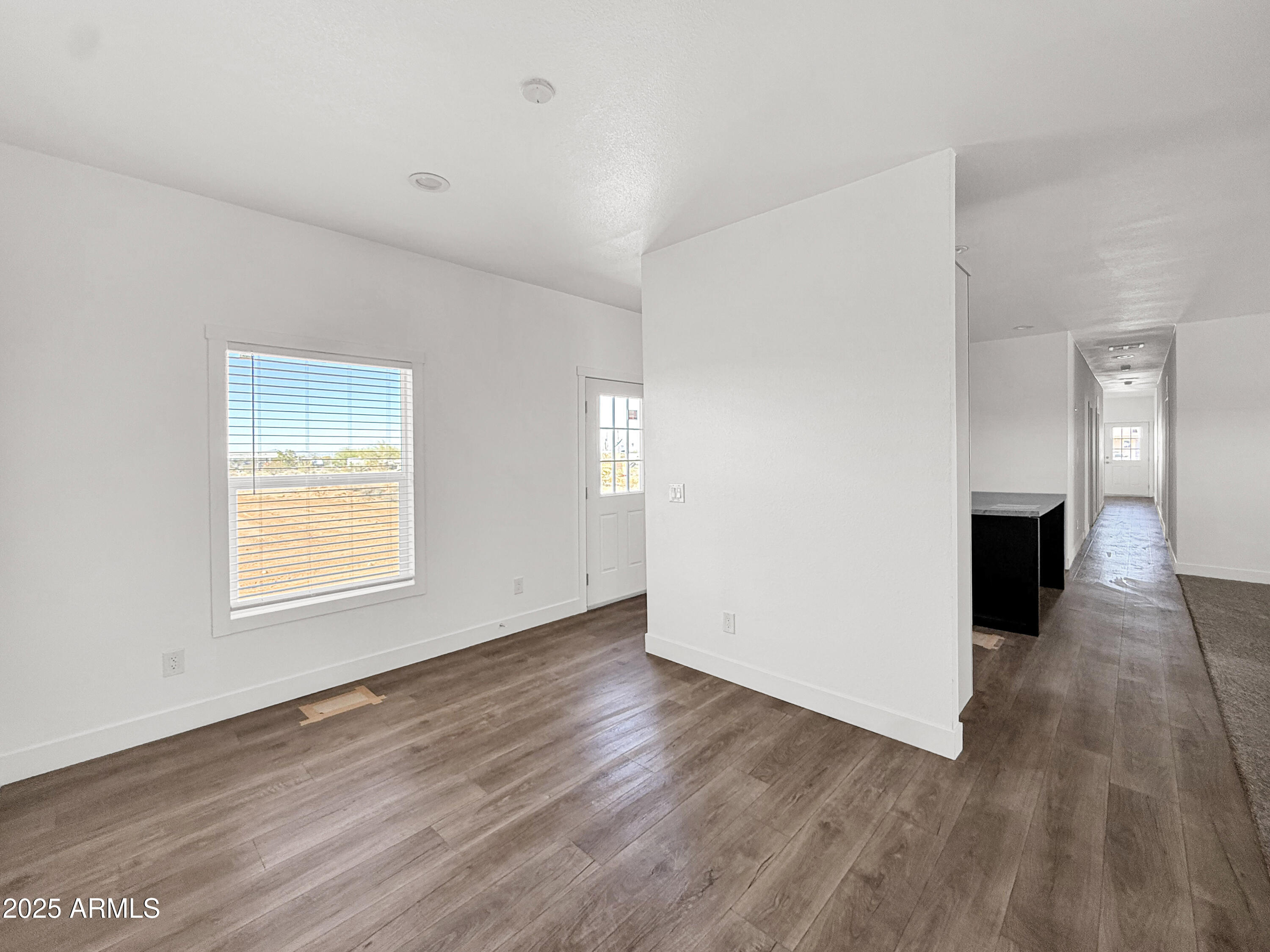 8548 North Page Road Florence, AZ 85132 - Photo 16 of 23 an empty room with wooden floor and windows