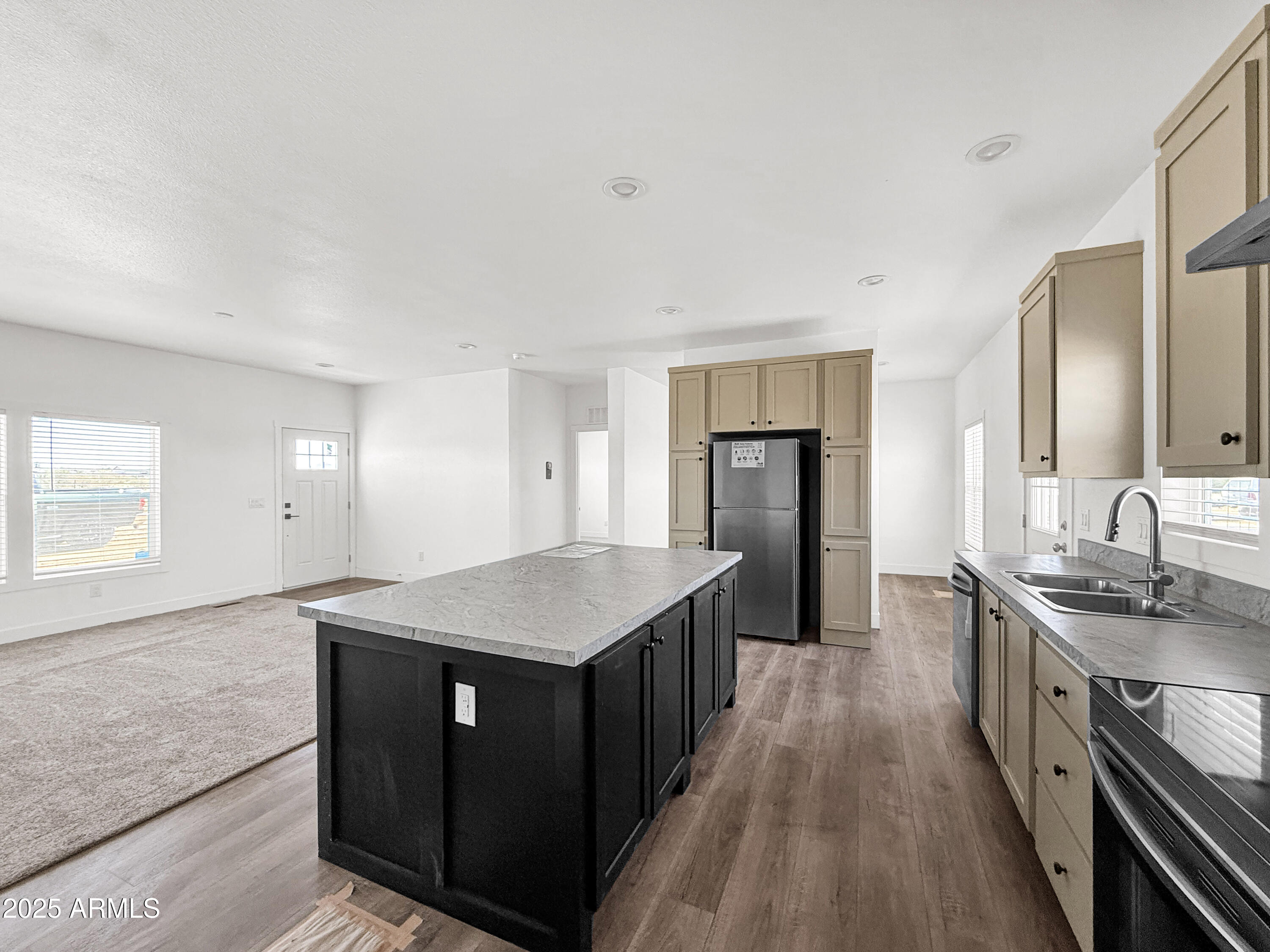 8548 North Page Road Florence, AZ 85132 - Photo 17 of 23 a kitchen with stainless steel appliances granite countertop a sink a stove and a wooden floors