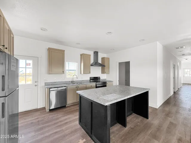 a large white kitchen with a sink and white cabinets