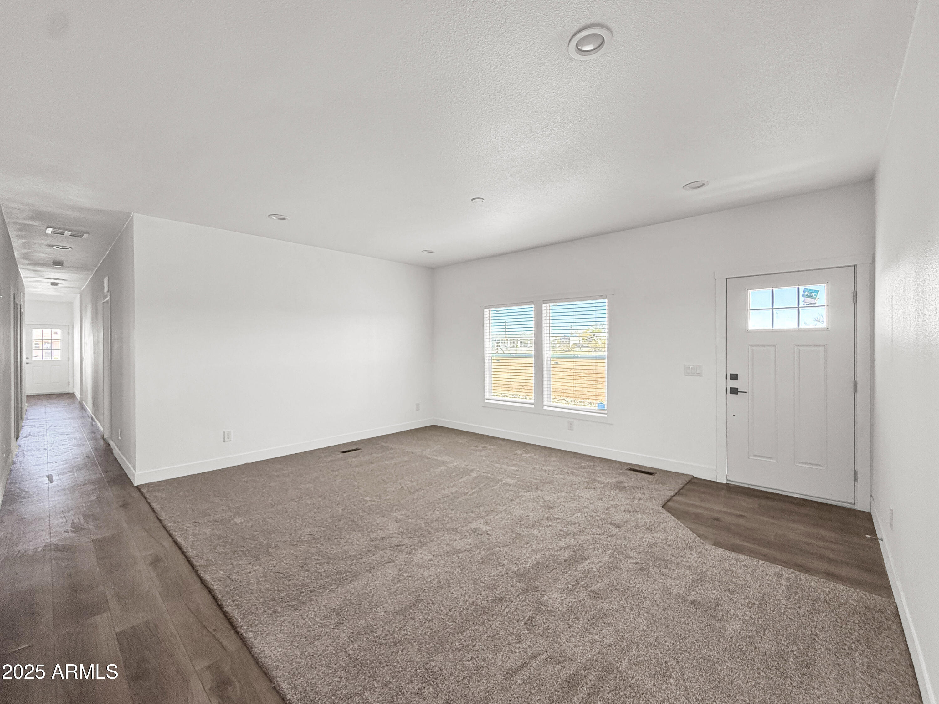 8548 North Page Road Florence, AZ 85132 - Photo 20 of 23 a view of an empty room with wooden floor and windows