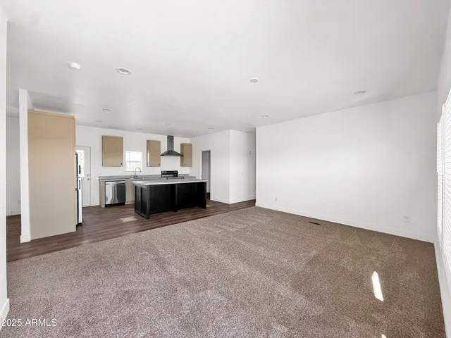 a spacious bathroom with a granite countertop toilet a double vanity sink a mirror and a shower